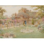 19th/20th C. ENGLISH SCHOOL READING IN THE GARDEN, SIGNED INDISTINCTLY, WATERCOLOUR. 36 x 53cms