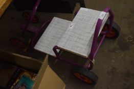 A scratchbuilt child's wooden and metal go-kart.