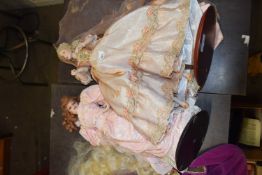 A Franklin Heirloom porcelain doll formed as a lady in pink gown with pearl-effect detail. Height