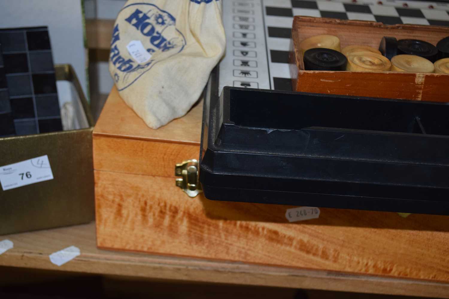 Box containing quantity of Isle of Man chess men and a set of draughts and other games