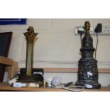 A Corintian column style table lamp and one other