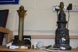 A Corintian column style table lamp and one other