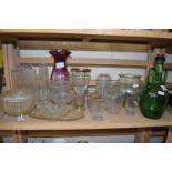 Group of drinking glasses and green glass bottle