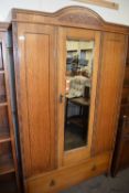 Early 20th Century oak wardrobe with mirrored door and drawer to base, 117cm wide
