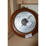 Small barometer in circular wooden case