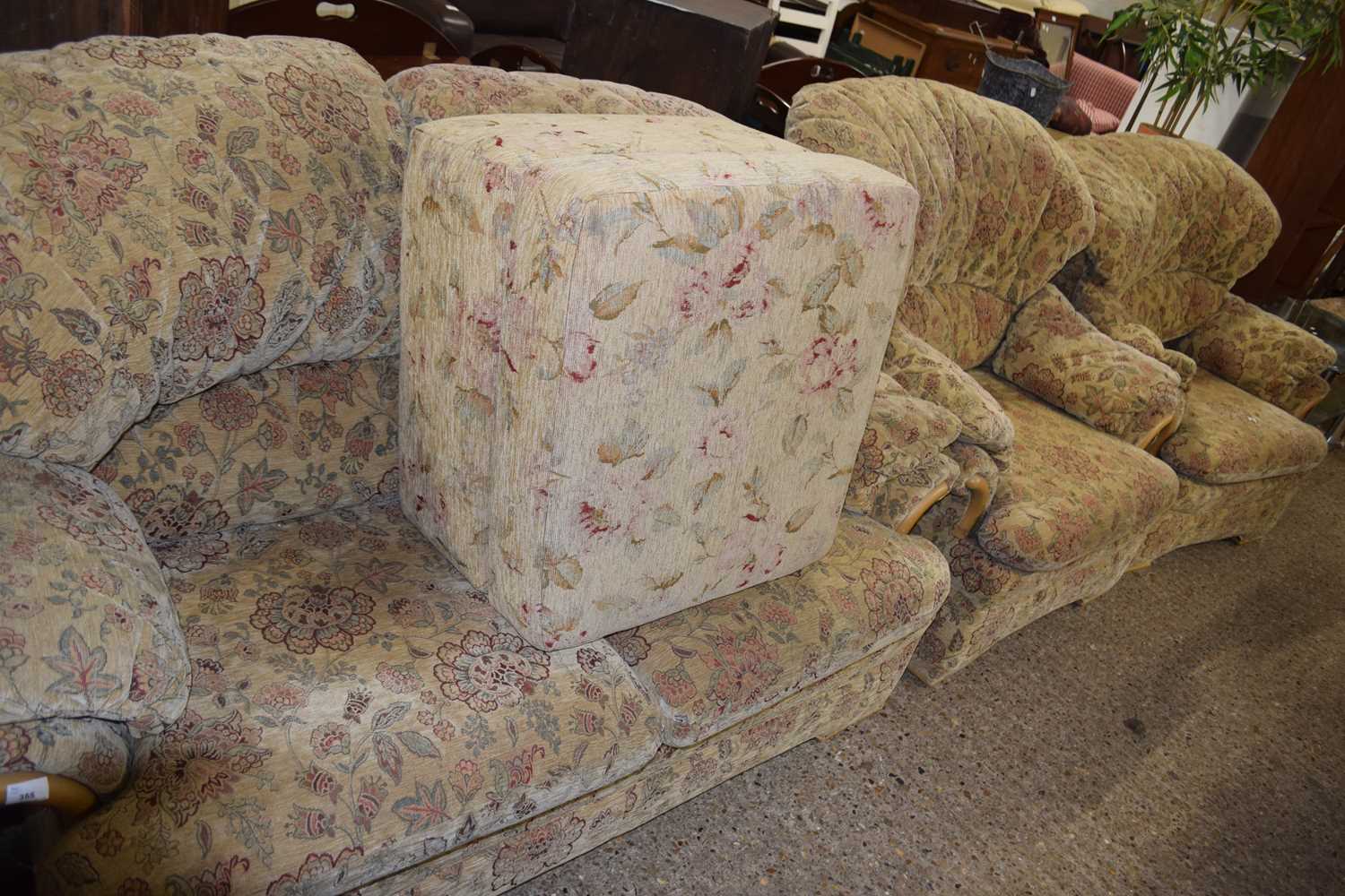 Floral upholstered three piece suite and accompanying footstool