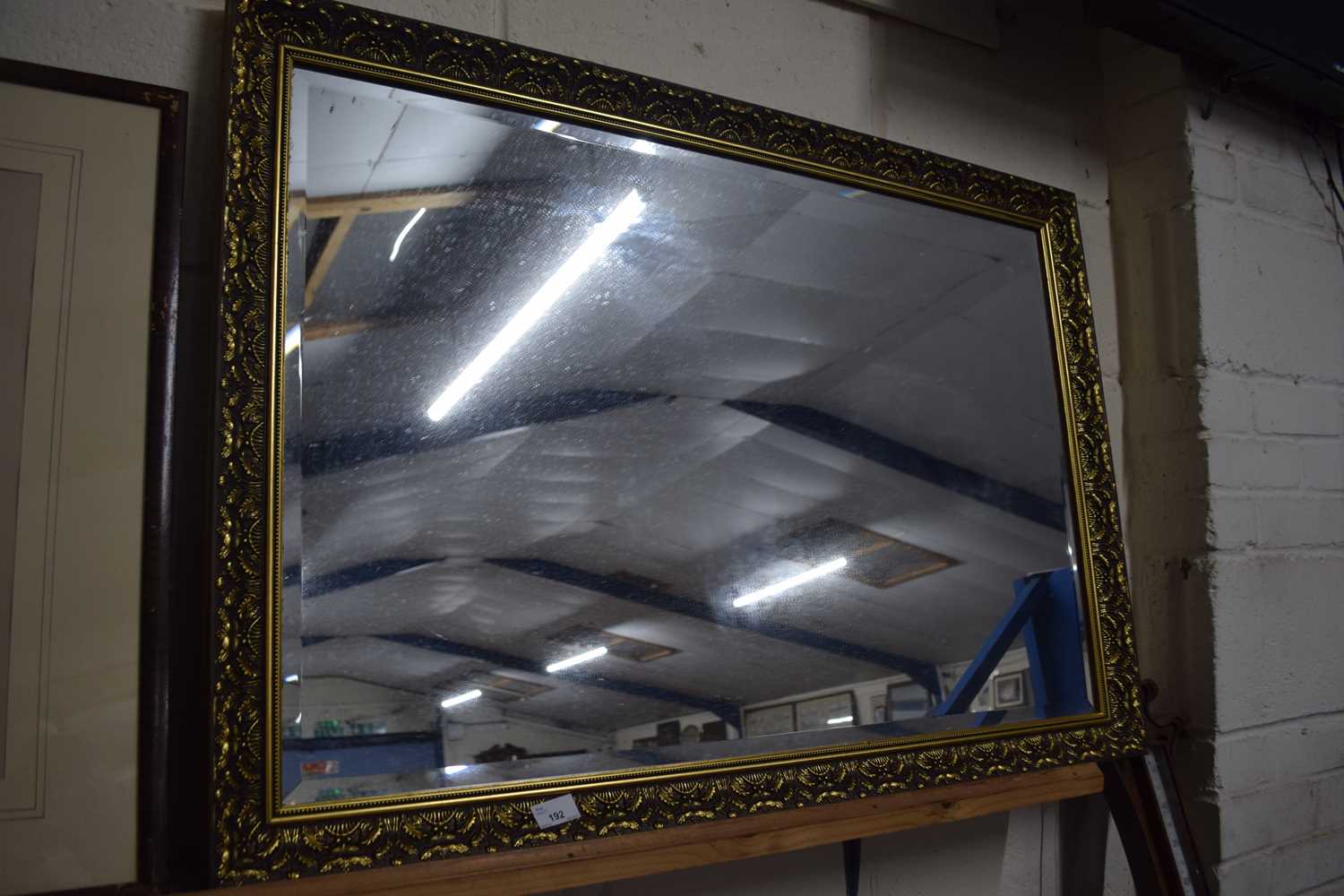 20th Century bevelled wall mirror in gilt effect frame