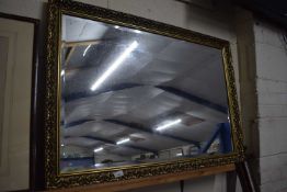 20th Century bevelled wall mirror in gilt effect frame