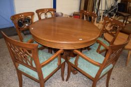 Modern light oak pedestal extending dining table together with six accompanying chairs