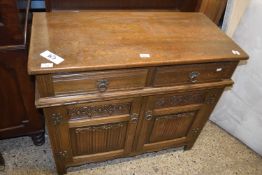 Modern oak dresser with a linen fold carved decoration