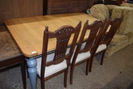 Modern light oak dining table raised on a painted frame