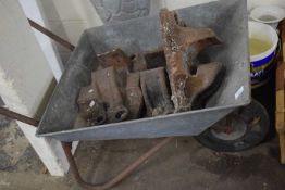 Wheelbarrow and three iron railway tie plates