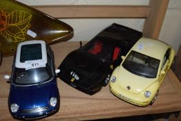 Three assorted toy cars to include Burago