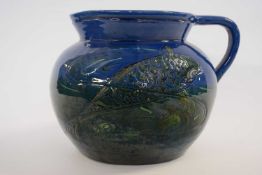 Large Barum jug decorated in green slip with fish