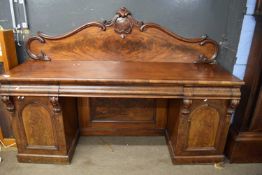 Large 19th Century mahogany twin pedestal side board with shaped back panel over a base with three