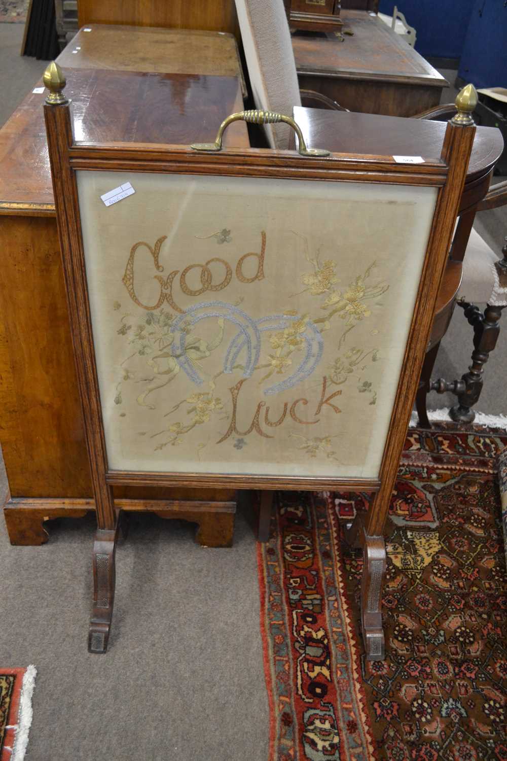 Late 19th/early 20th Century oak framed fire screen with central needlework panel marked 'Good