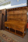 A good quality reproduction Georgian style oak dresser with two shelf back over a base section