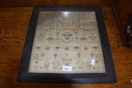 19th Century needlework sampler decorated with rows of text, stylised plants and animals and