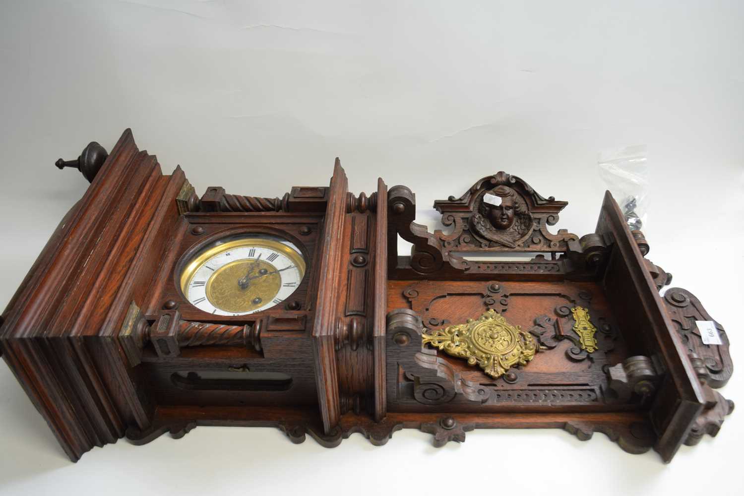 Late 19th Century German wall clock with elaborate architectural oak case with figural pediment,