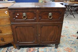 A Georgian mahogany secretaire cabinet with single fitted drawer with drop down front and lions head
