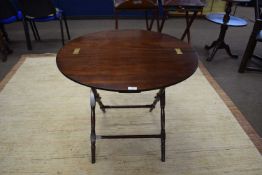 Reproduction mahogany circular coaching style table with hinged circular top and a turned frame,