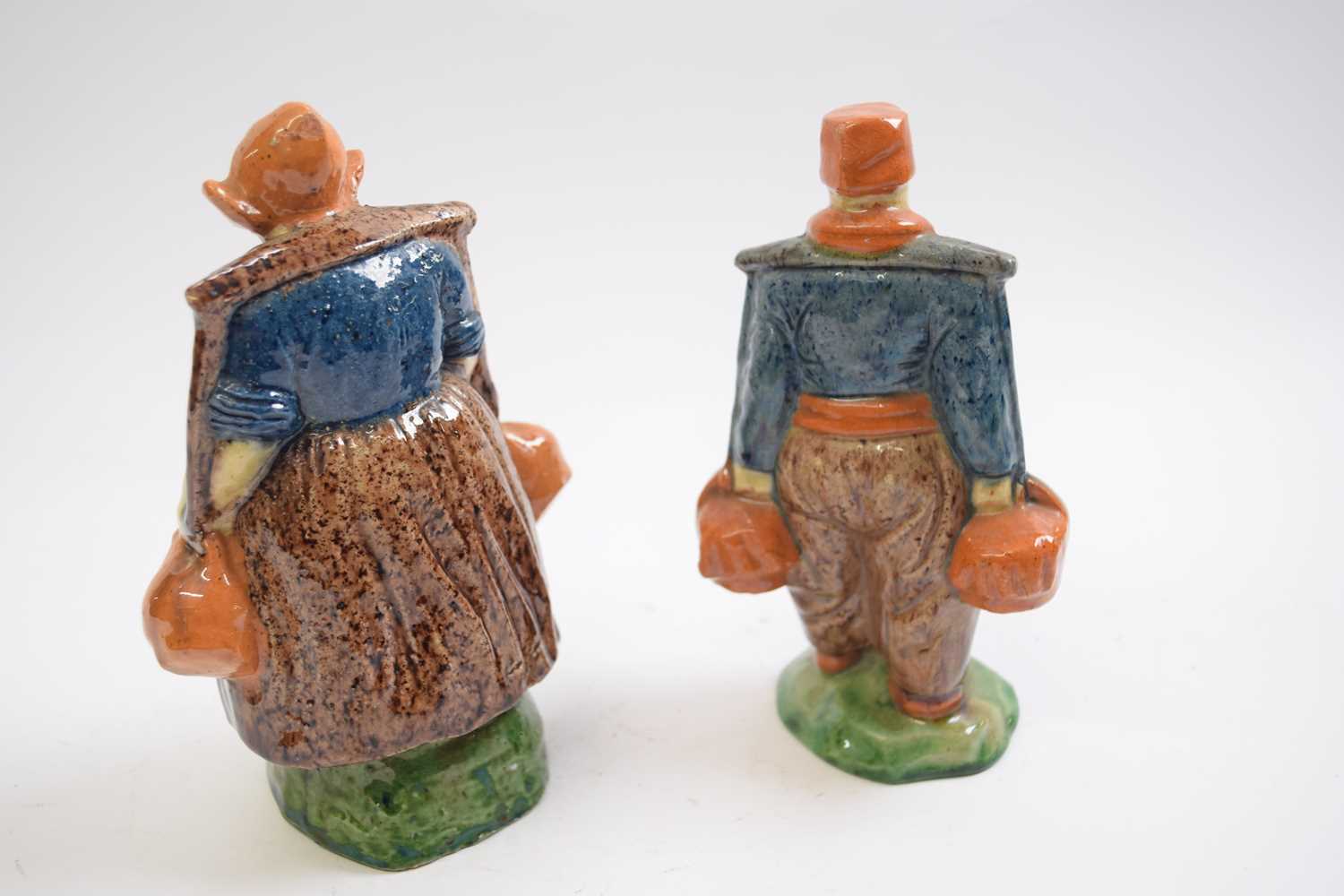 Pair of early 20th Century Dutch pottery figures of a boy and a girl in Maiolica style glazes - Image 2 of 3