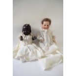 Two further dolls, one with a Heubach bisque head, the second doll marked Reliable Doll Company,