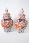 Pair of Japanese porcelain vases and large covers, decorated in Imari style with fish, 36cm high