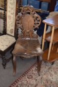 Late 19th century Black Forest hall chair with elaborately carved and pierced back over a seat