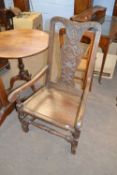 18th Century large oak armchair with carved splat back hard seat and turned front stretcher, 103cm