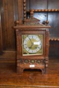 Late 19th Century mantel clock in architectural oak case with applied metal mounts fitted with a