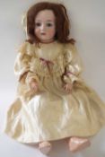 German bisque headed doll, the head marked C Burgan with original clothing