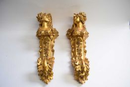 Pair of 20th Century composition gilt curtain pole supports, classical style decorated with