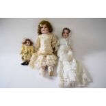 Group of three small dolls with German bisque heads, one marked S&H for Hanna, Germany, with