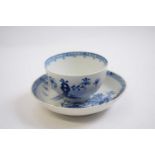 Lowestoft tea bowl and a saucer, both with blue and white designs