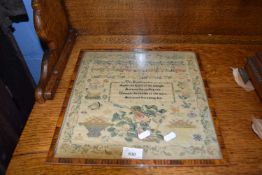 Victorian needlework sampler decorated with rows of religious text, alphabet and numbers, surrounded