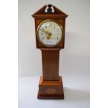 Small model of a long case clock with inlay together with a brass carriage clock