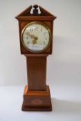 Small model of a long case clock with inlay together with a brass carriage clock