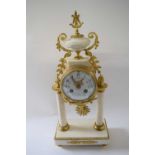 Mantel clock in French Empire style with alabaster columns on rectangular alabaster style base,