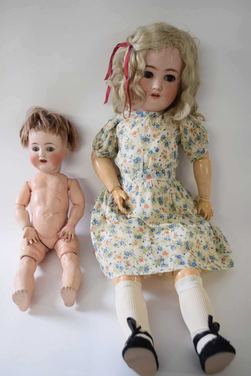 Simon & Halbig doll in original clothing together with a smaller doll marked AB (2)