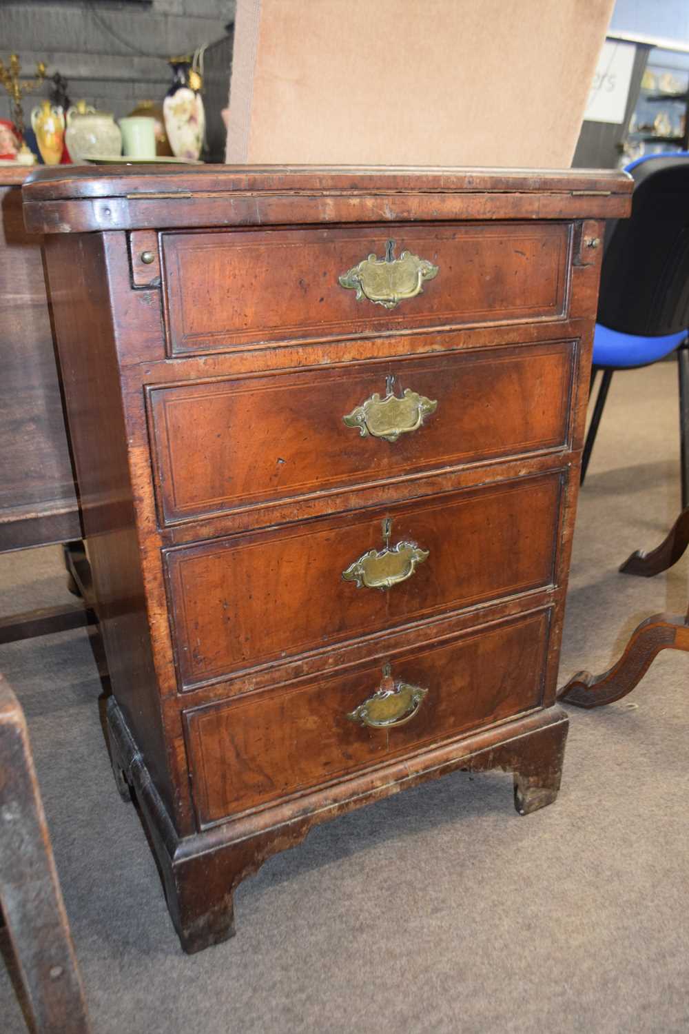 Small 18th Century and later walnut and inlaid bachelors chest with shaped flip top over four