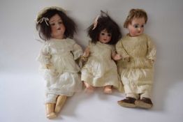 Three smaller dolls including a Limoges doll and two German dolls in original clothing