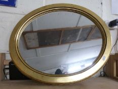 Modern oval wall mirror in gilt finish frame