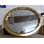 Modern oval wall mirror in gilt finish frame