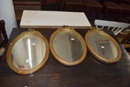 Set of three oval wall mirrors in plasterwork frames