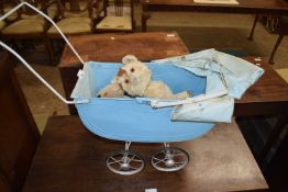 Dolls pram containing vintage soft toys