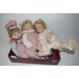 Three porcelain headed dolls