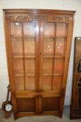 20th Century oak bookcase cabinet with glazed top section and cupboard base decorated with floral