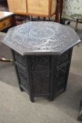 Indian hardwood folding occasional table with octagonal top with elaborate floral carved