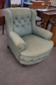 A good quality late 19th or early 20th Century deep seated armchair with green buttoned upholstery